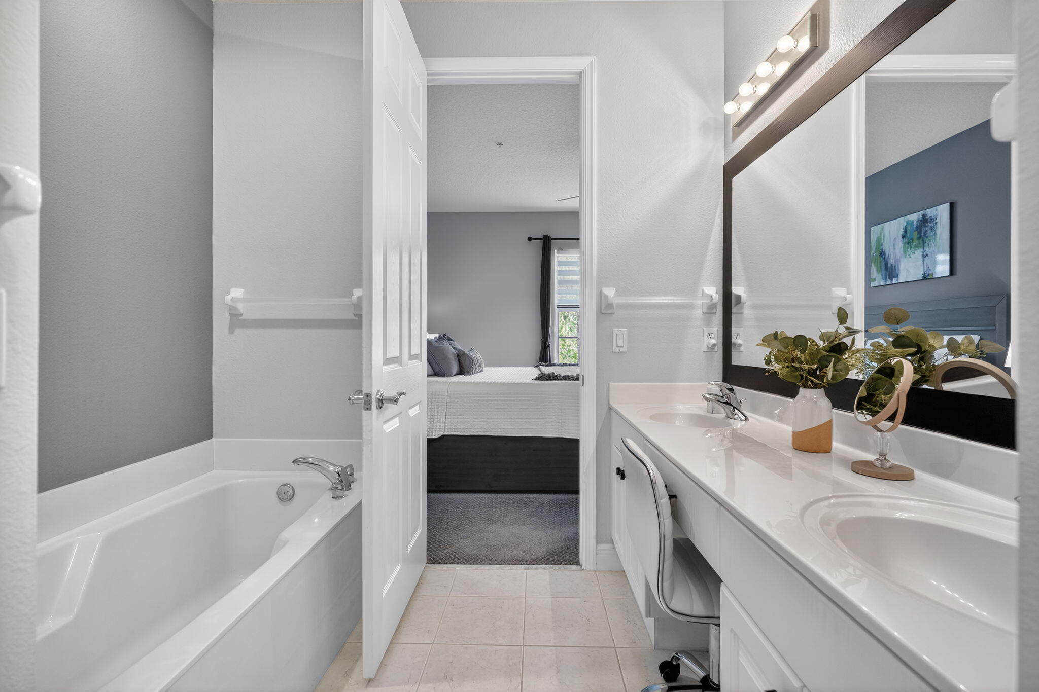 108 Morning Dew Circle Jupiter, FL 33458 - Photo 25 of 46 a bathroom with a tub a sink and a large mirror