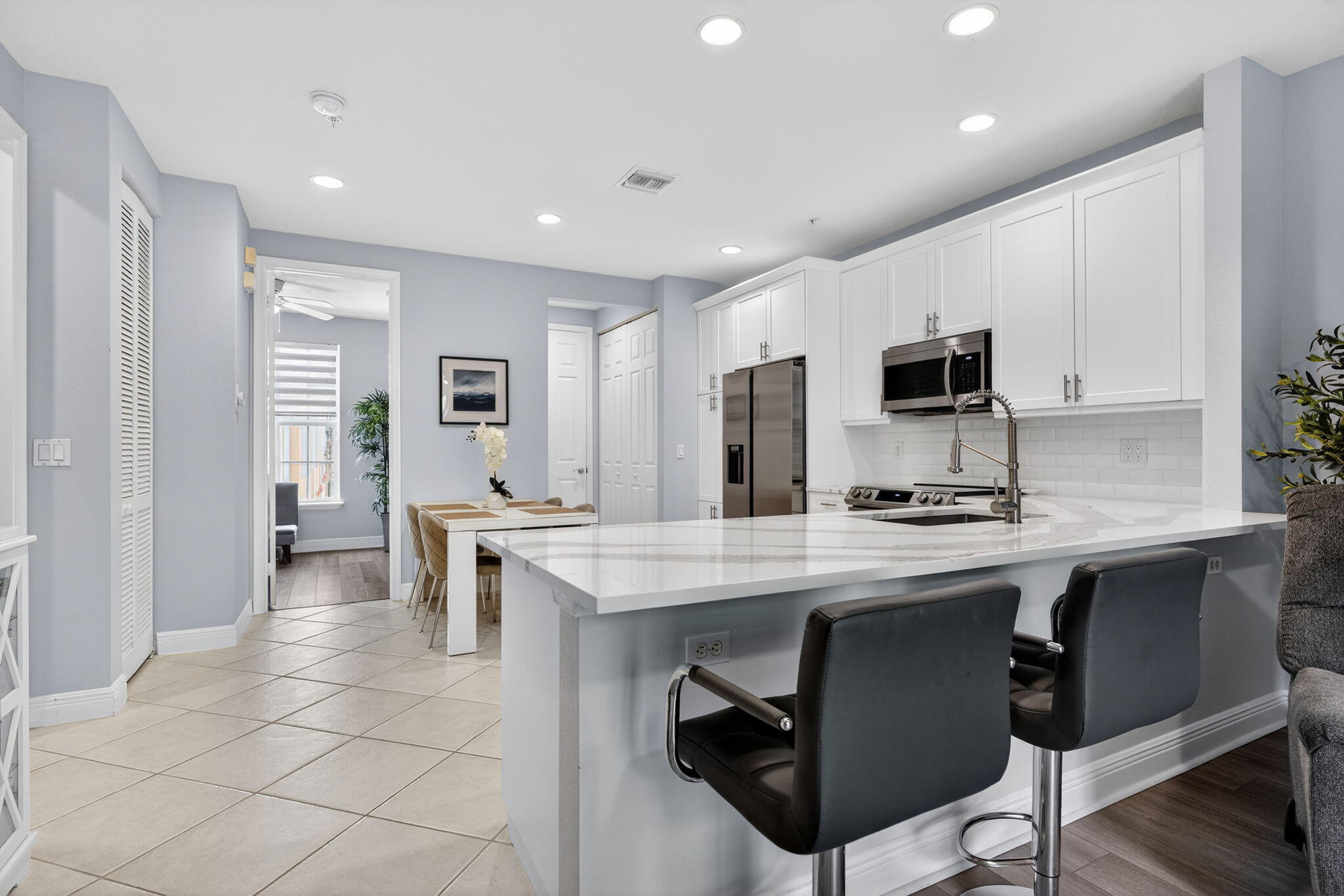 108 Morning Dew Circle Jupiter, FL 33458 - Photo 8 of 46 a kitchen with appliances a sink a counter top space cabinets and a window