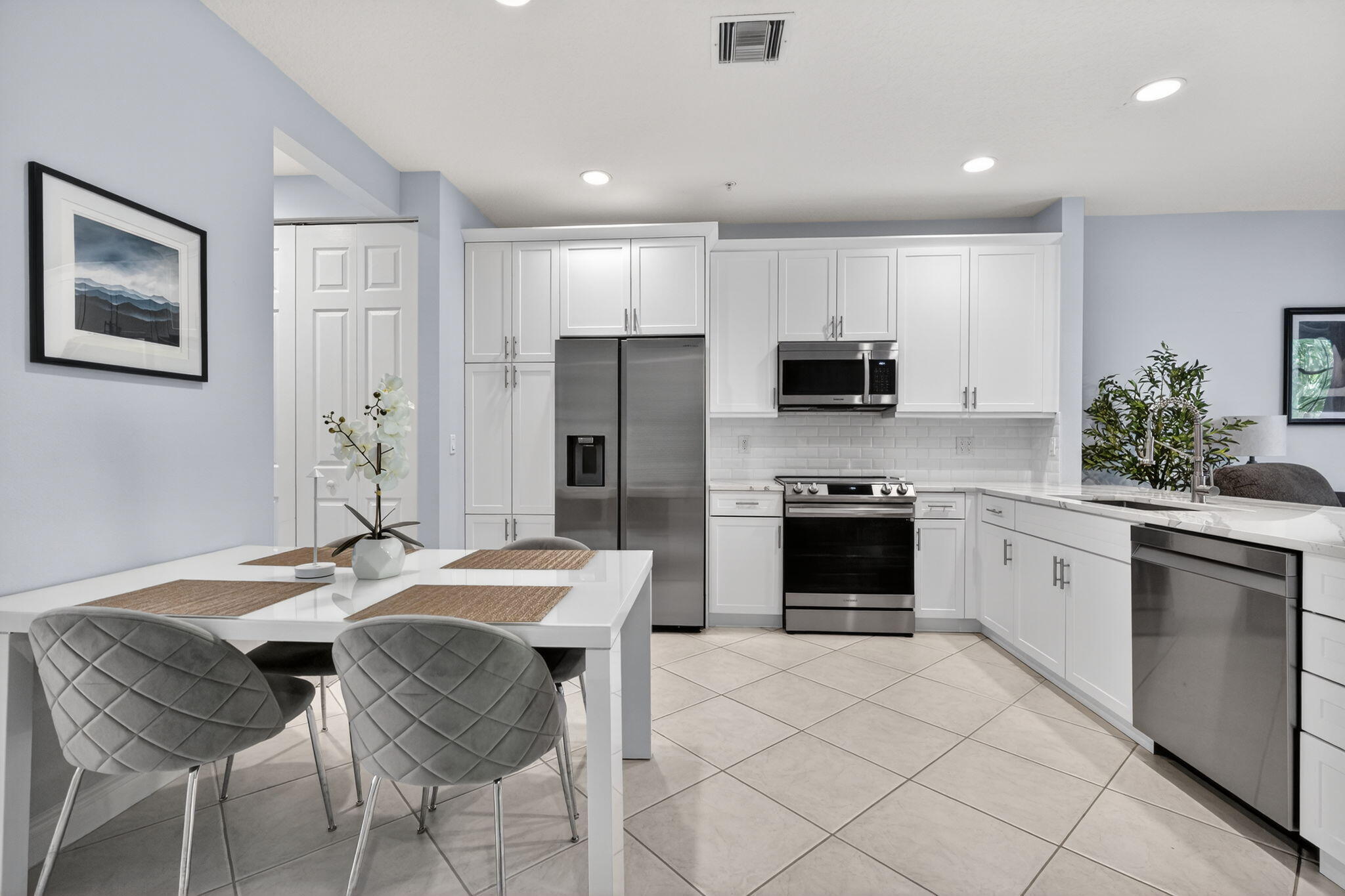 108 Morning Dew Circle Jupiter, FL 33458 - Photo 9 of 46 a kitchen with a cabinets and refrigerator stove top oven