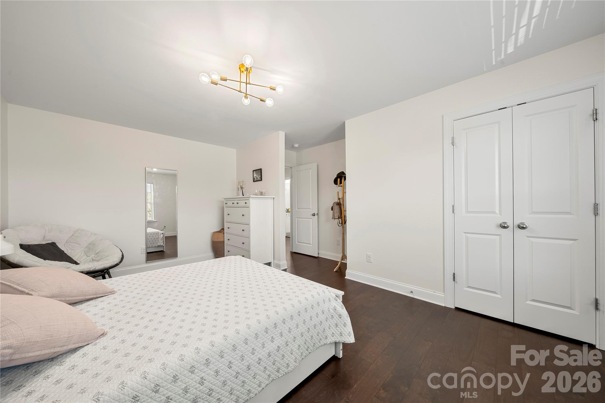 11266 Trailside Road Concord, NC 28027 - Photo 27 of 48 a bedroom with a large bed and a chandelier