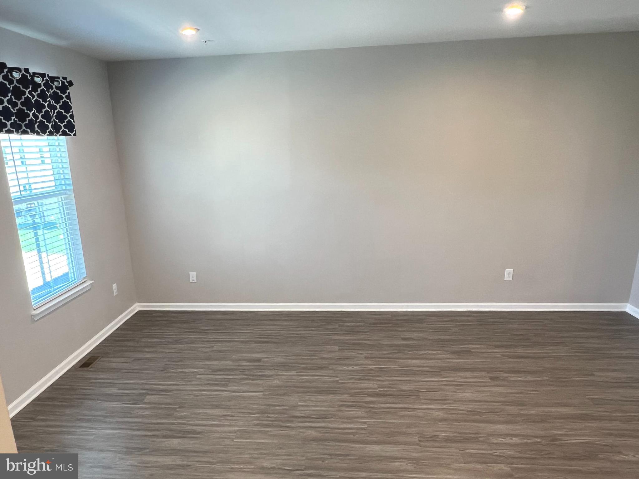 619 Quarry Point Road Malvern, PA 19355 - Photo 10 of 24 a view of an empty room with wooden floor and a window