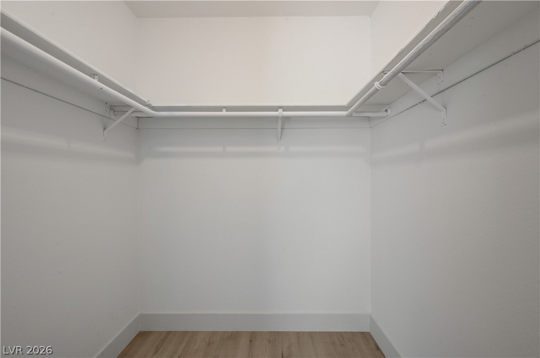 6505 Deadwood Road Las Vegas, NV 89108 - Photo 24 of 33 Ample hanging space and light wood flooring complete this organized closet.