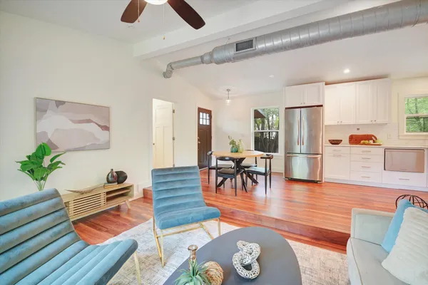 a living room with furniture and wooden floor
