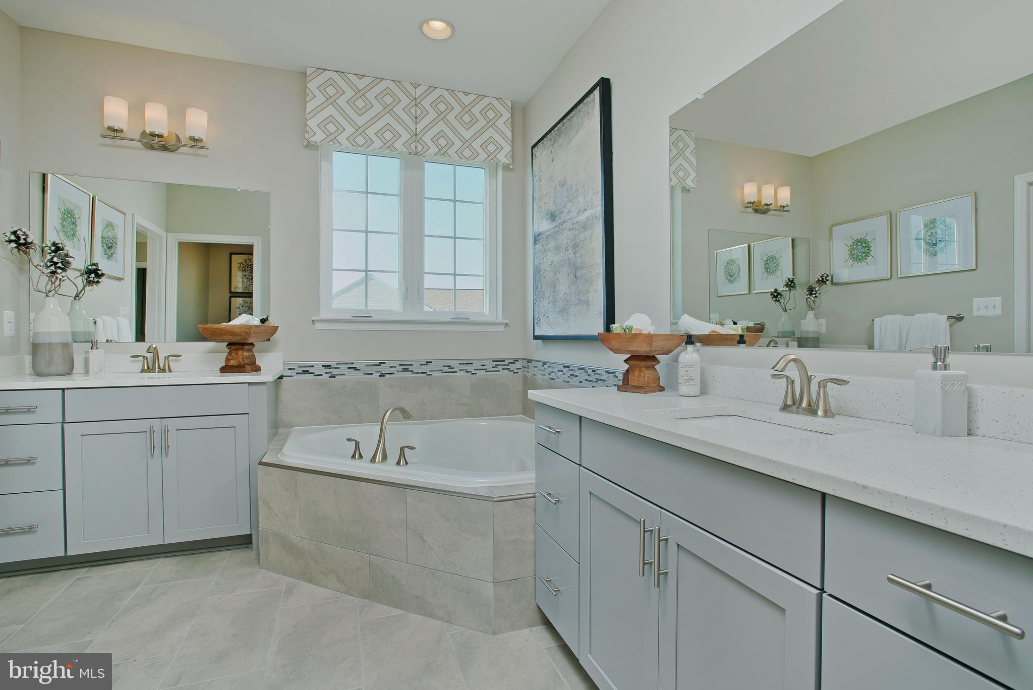 14026 Rolling Pasture Road Boyds, MD 20841 - Photo 21 of 39 a bathroom with a tub double sink and mirror