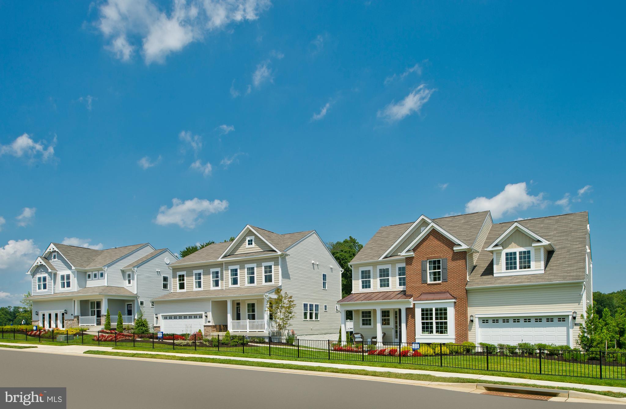 14026 Rolling Pasture Road Boyds, MD 20841 - Photo 34 of 39 a front view of residential houses with yard and green space