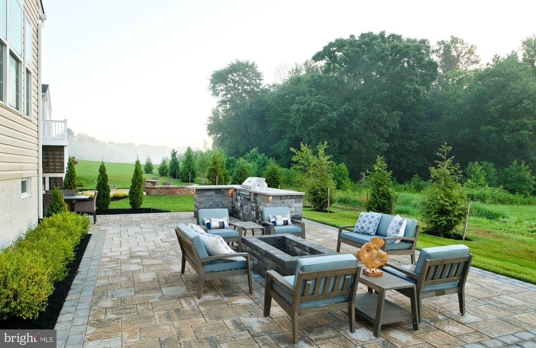 14026 Rolling Pasture Road Boyds, MD 20841 - Photo 38 of 39 a view of a patio with table and chairs potted plants with large tree