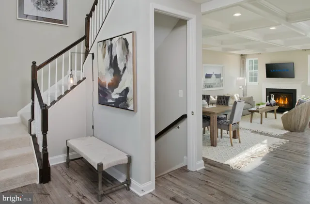 a dining room with wooden floor and a hallway