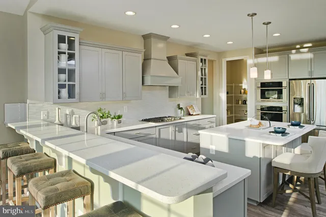 a kitchen with a table chairs stove and kitchen island