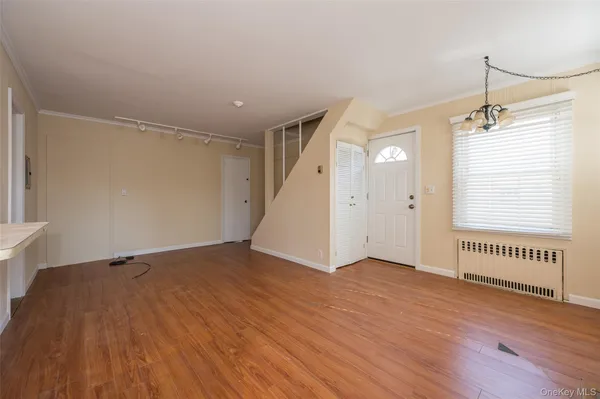 a kitchen with a sink a stove a refrigerator and white cabinets