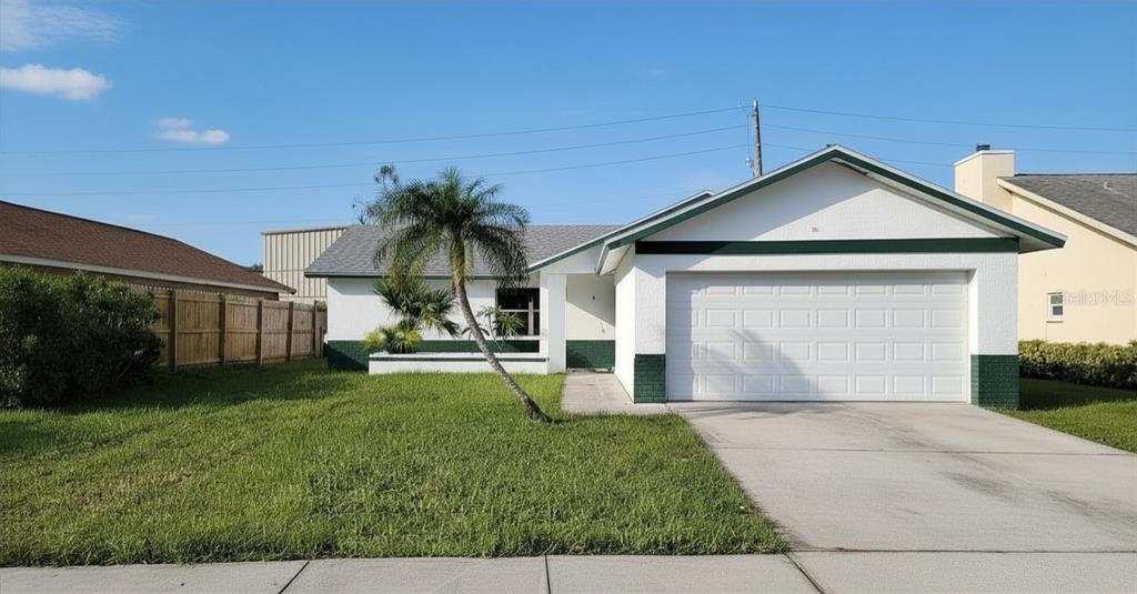 a view of a house with a yard and garage