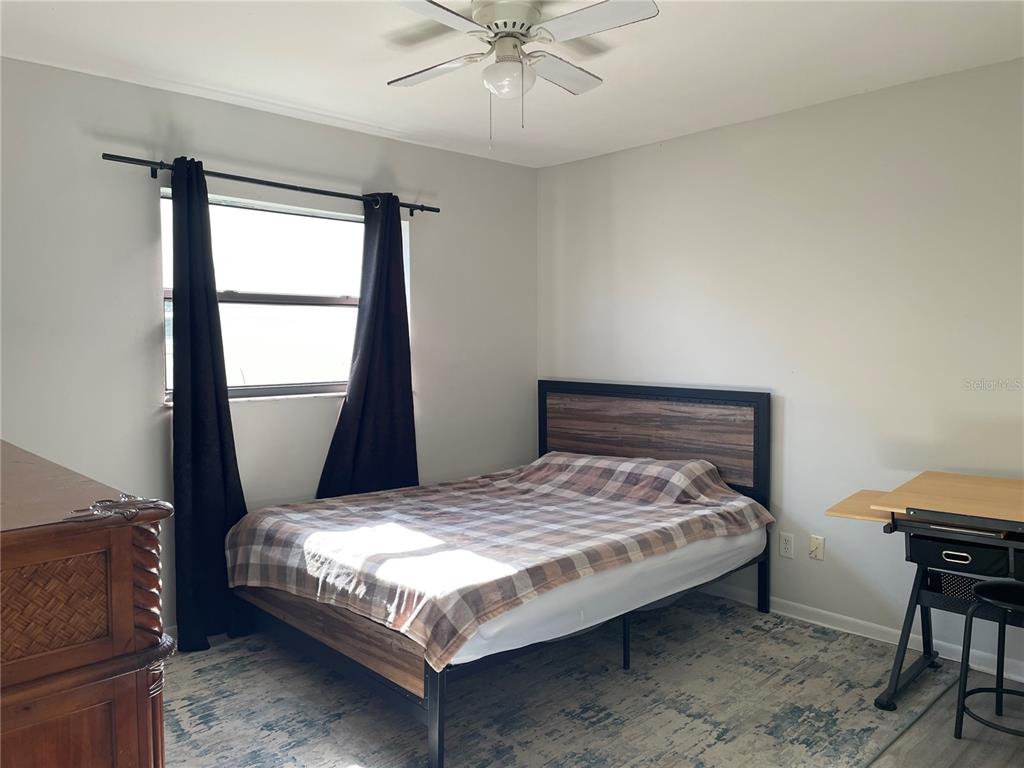 7199 121st Terrace Largo, FL 33773 - Photo 12 of 16 a bedroom with a bed and a window