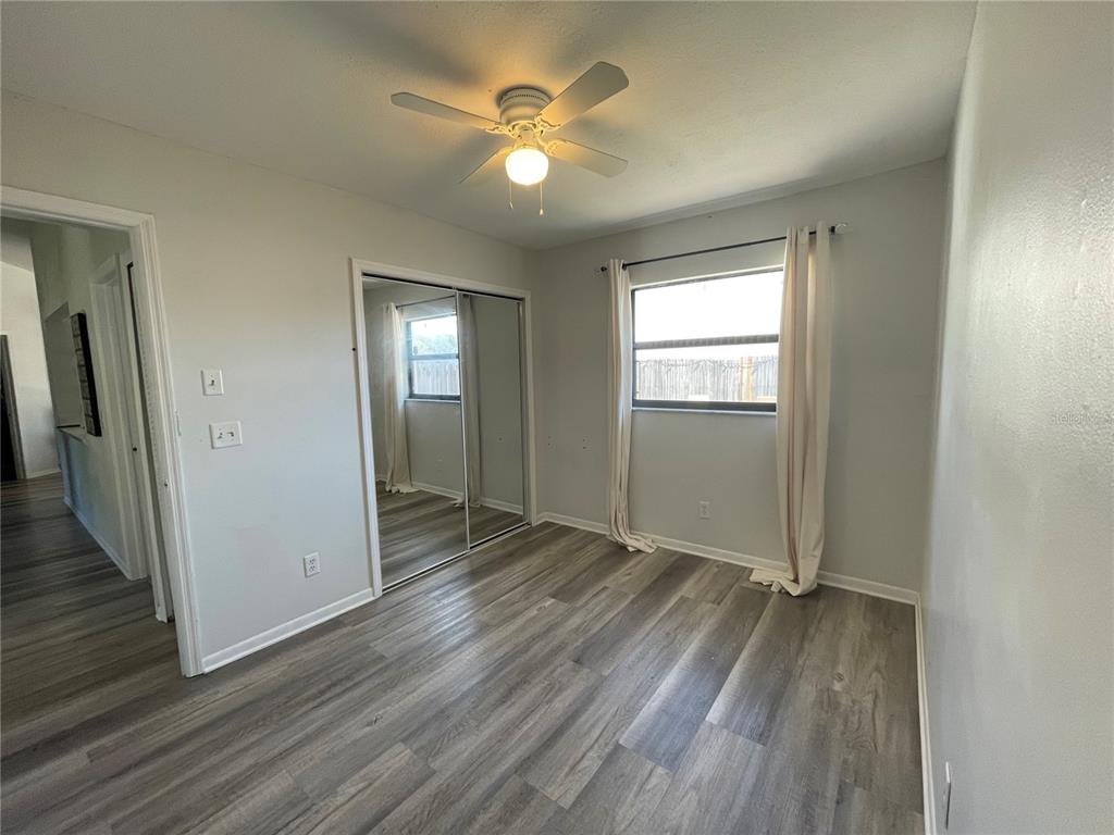 7199 121st Terrace Largo, FL 33773 - Photo 16 of 16 an empty room with wooden floor and a ceiling fan