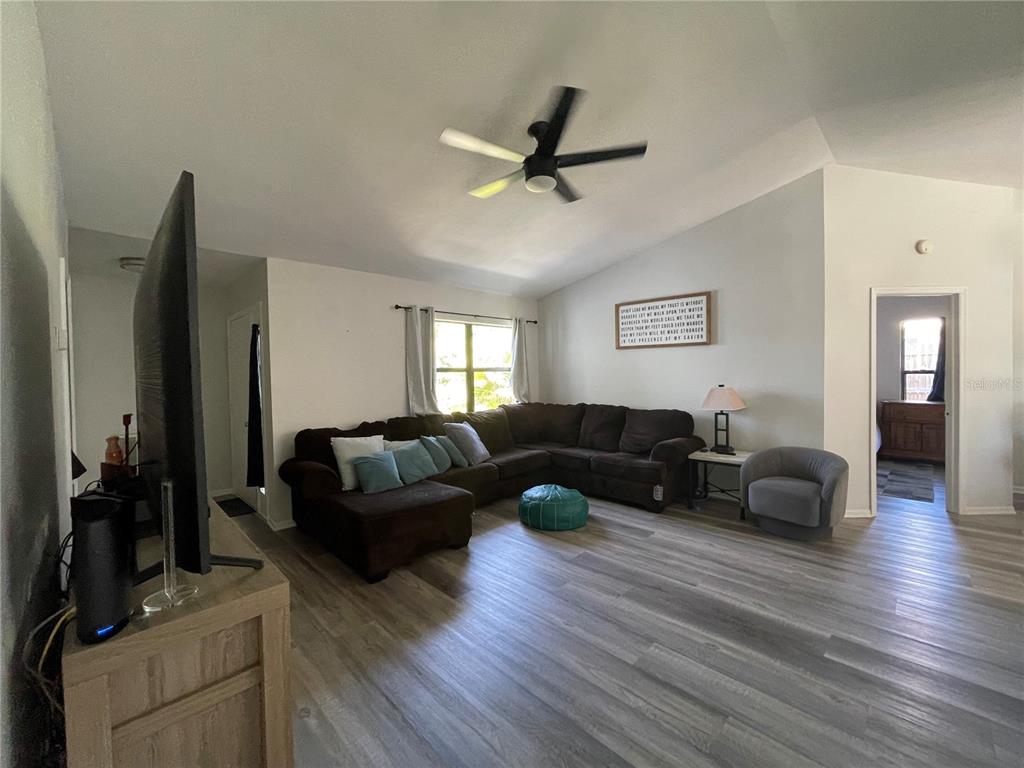 7199 121st Terrace Largo, FL 33773 - Photo 2 of 16 a living room with furniture and a wooden floor