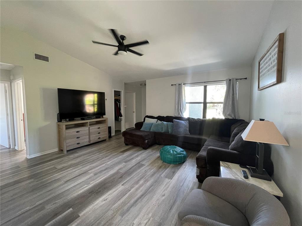 7199 121st Terrace Largo, FL 33773 - Photo 3 of 16 a living room with furniture and a flat screen tv
