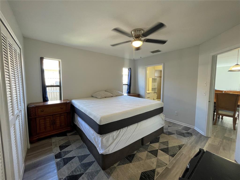 7199 121st Terrace Largo, FL 33773 - Photo 10 of 16 a spacious bedroom with a bed and a chandelier