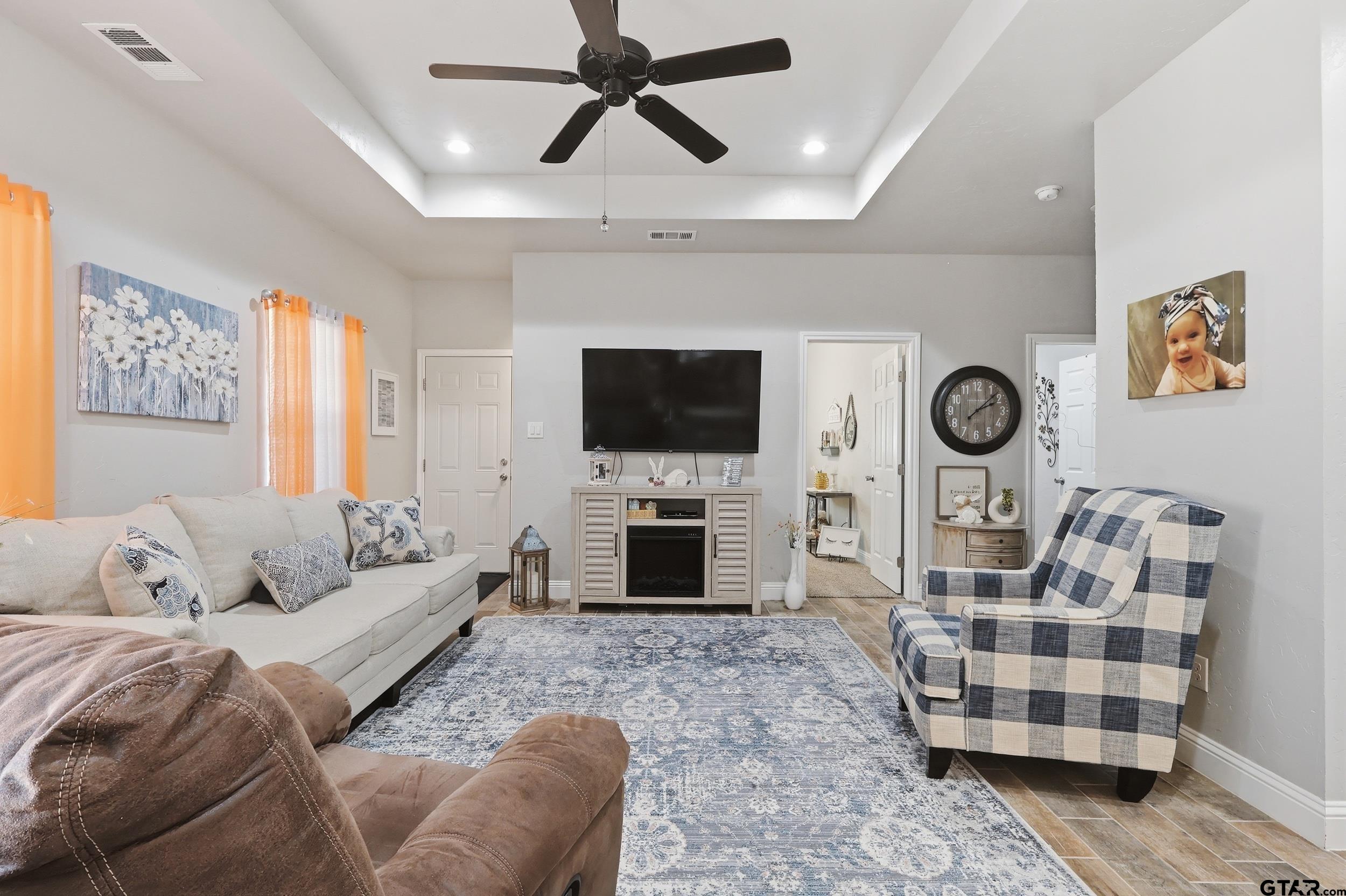 168 Tupelo Street Pittsburg, TX 75686 - Photo 11 of 28 a living room with furniture and a flat screen tv