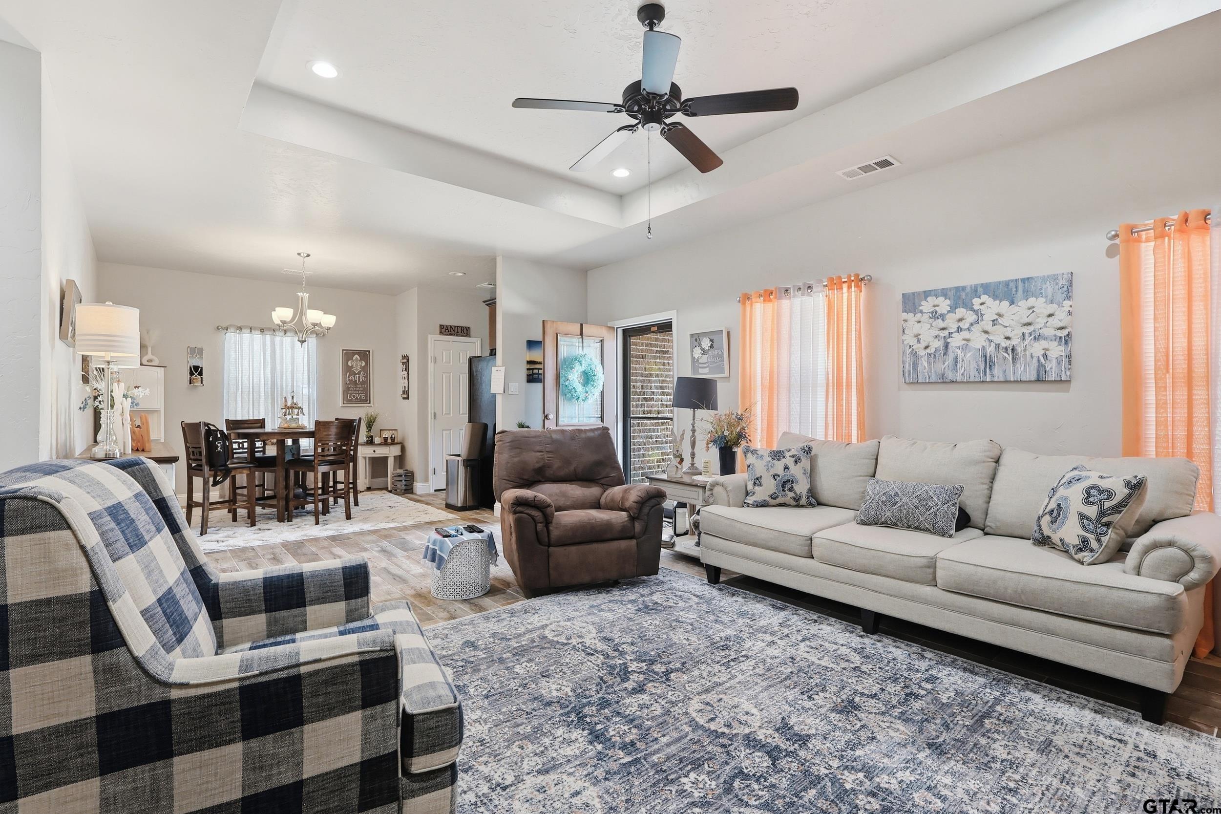 168 Tupelo Street Pittsburg, TX 75686 - Photo 13 of 28 a living room with furniture and a chandelier