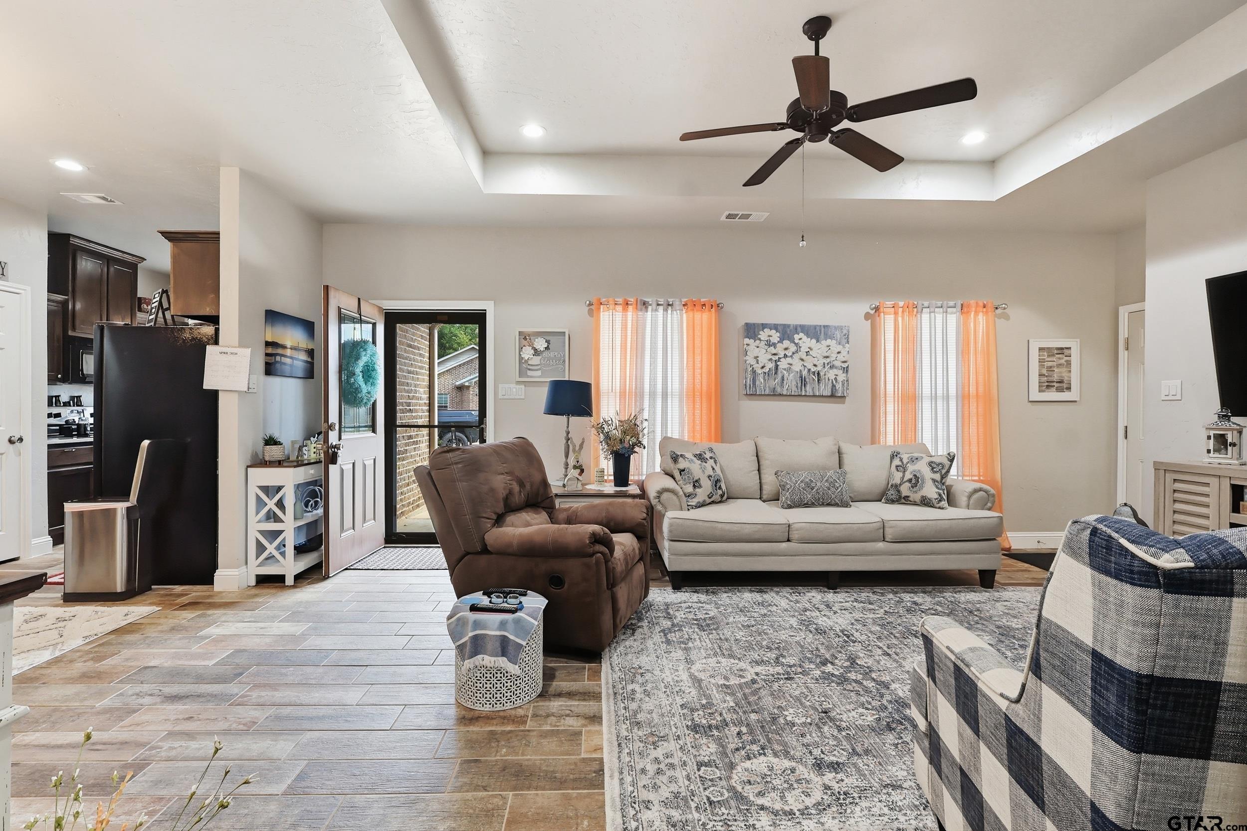 168 Tupelo Street Pittsburg, TX 75686 - Photo 14 of 28 a living room with furniture and a flat screen tv