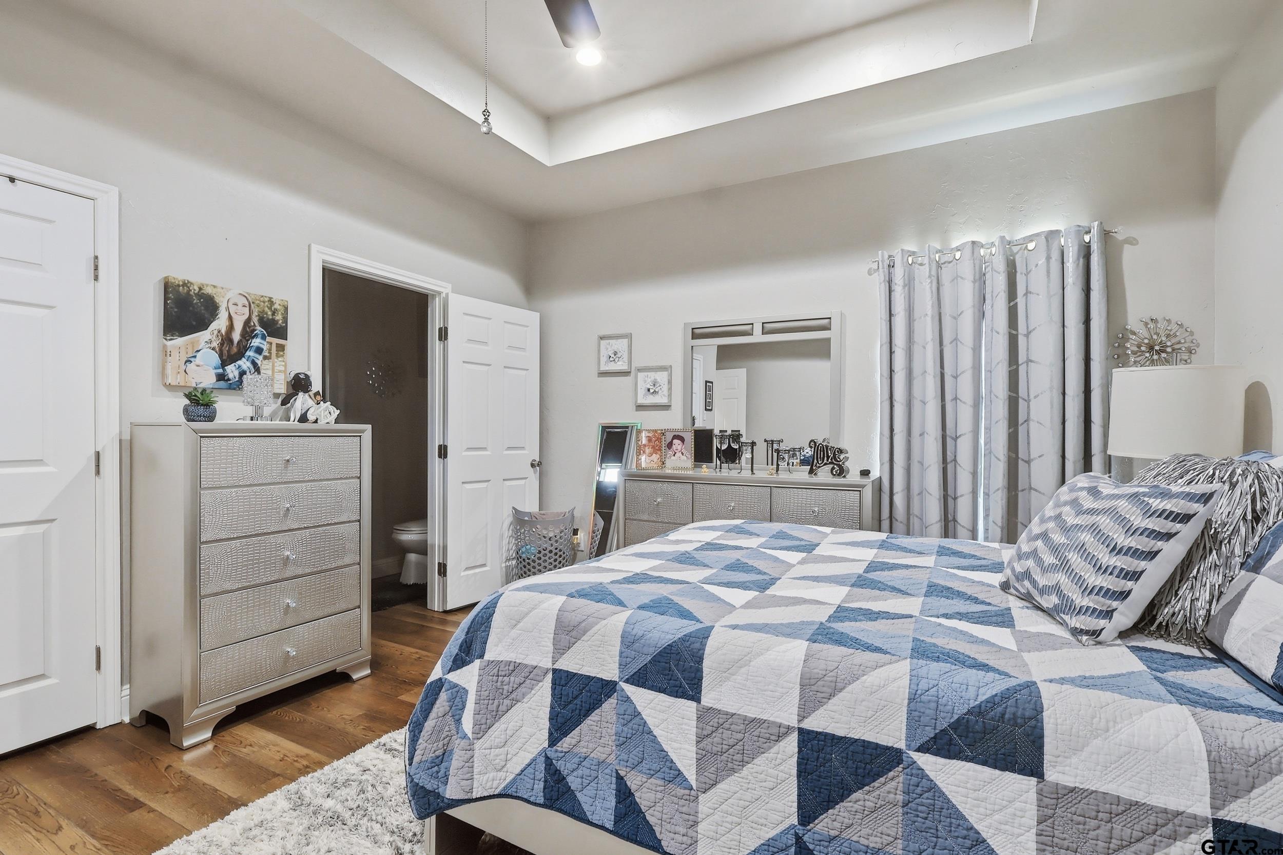 168 Tupelo Street Pittsburg, TX 75686 - Photo 17 of 28 a bedroom with a bed and a dresser