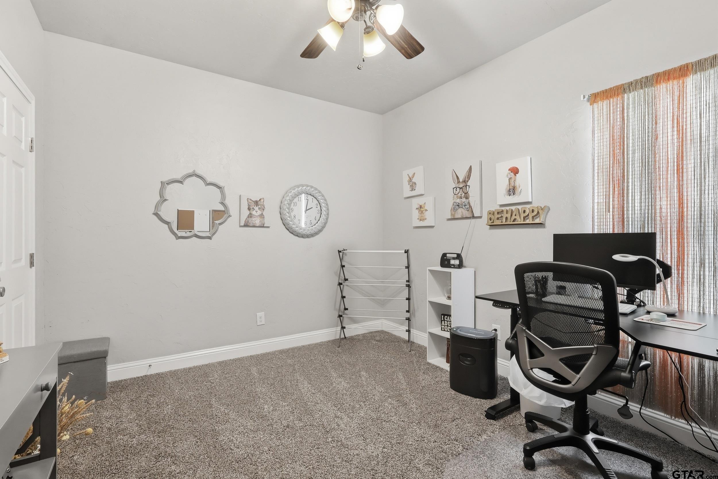168 Tupelo Street Pittsburg, TX 75686 - Photo 20 of 28 a view of a workspace with furniture and a window