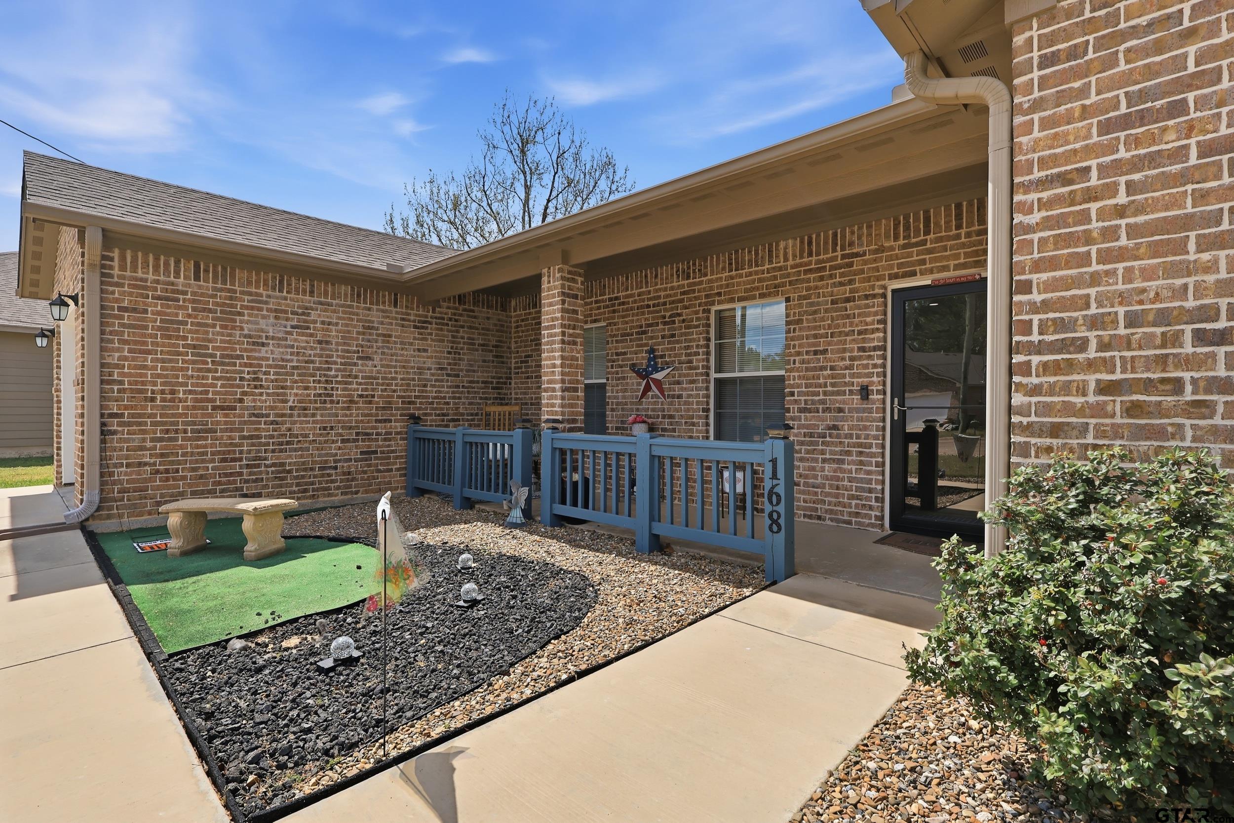 168 Tupelo Street Pittsburg, TX 75686 - Photo 4 of 28 a front view of a house with garden