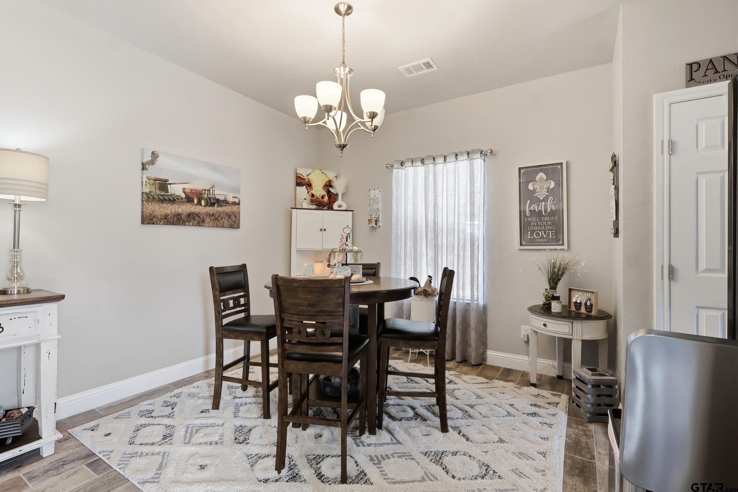 168 Tupelo Street Pittsburg, TX 75686 - Photo 10 of 28 a view of a dining room with furniture and chandelier