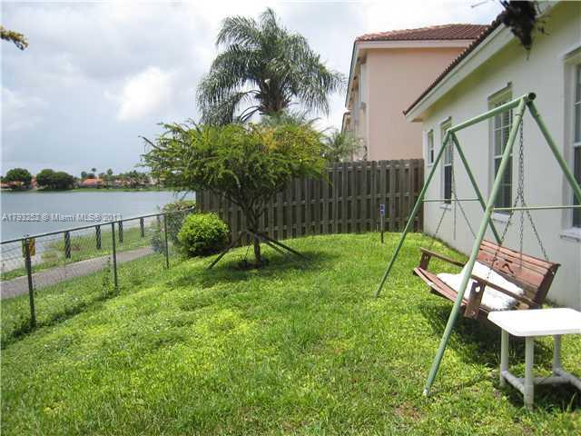 9216 Southwest 213th Lane Miami, FL 33189 - Photo 11 of 13 a view of a chair and table in backyard of the house