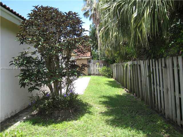 9216 Southwest 213th Lane Miami, FL 33189 - Photo 12 of 13 a backyard of a house with lots of green space