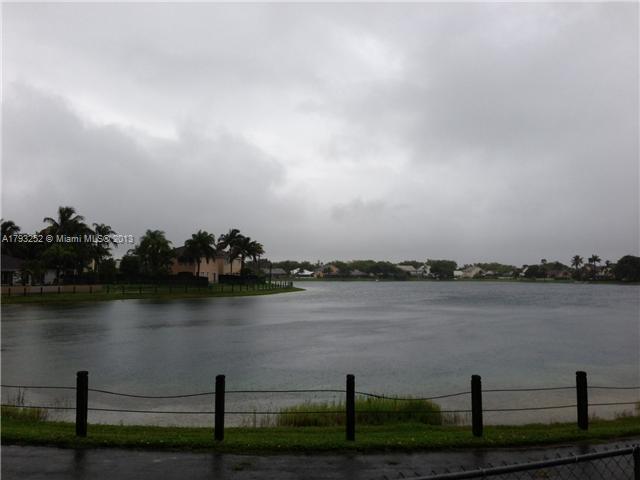9216 Southwest 213th Lane Miami, FL 33189 - Photo 13 of 13 a view of a lake with houses in outdoor space