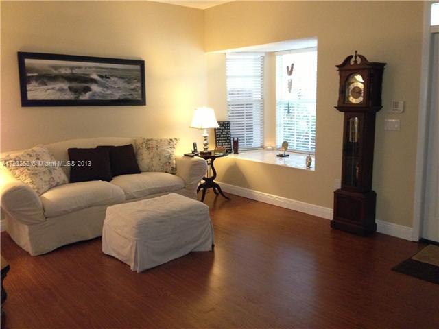 9216 Southwest 213th Lane Miami, FL 33189 - Photo 2 of 13 a living room with furniture and a large window