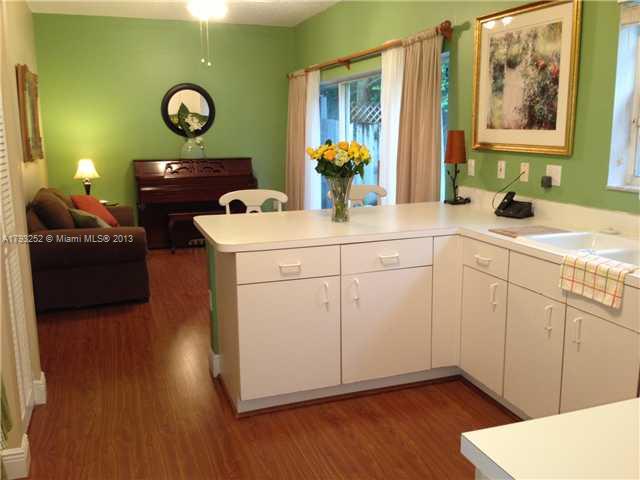 9216 Southwest 213th Lane Miami, FL 33189 - Photo 4 of 13 a kitchen with a sink and wooden floor