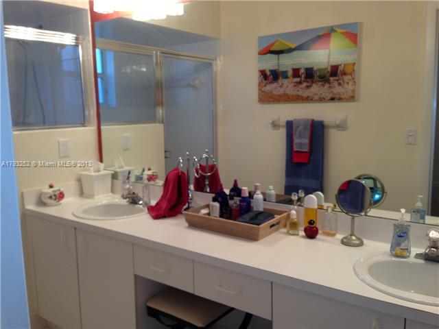 9216 Southwest 213th Lane Miami, FL 33189 - Photo 8 of 13 a bathroom with a sink and a mirror