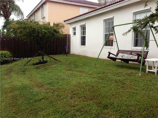 9216 Southwest 213th Lane Miami, FL 33189 - Photo 9 of 13 a small garden in the back yard