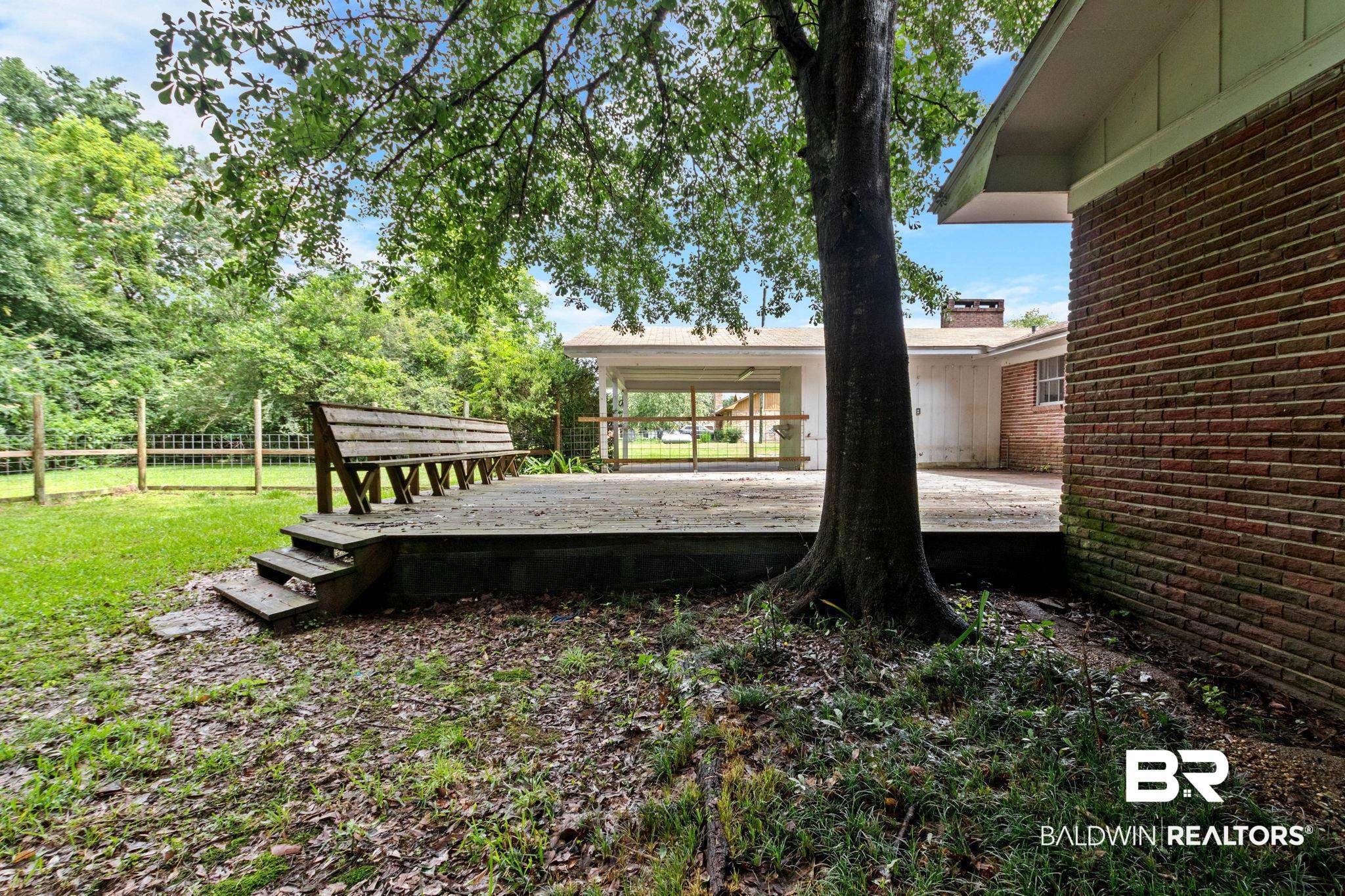 384 Old Bratt Road Atmore, AL 36502 - Photo 60 of 64 Expansive outdoor deck with built-in bench seating, accessible via steps