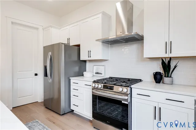 a view of staircase with wooden floor and white walls