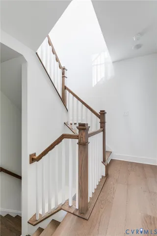 a view of staircase with railing and white walls