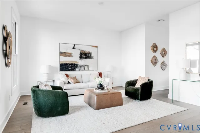 a kitchen with kitchen island a dining table chairs stainless steel appliances and cabinets