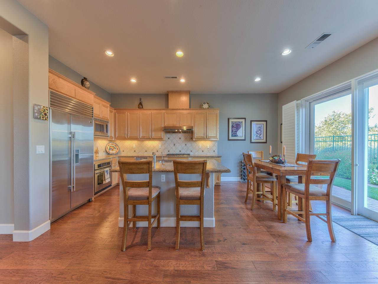 1975 Killarney Court Gilroy, CA 95020 - Photo 15 of 64 a dining room with stainless steel appliances wooden floors a table and chairs