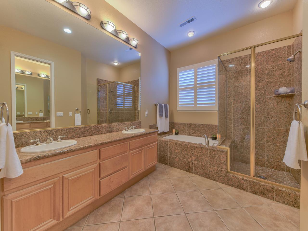 1975 Killarney Court Gilroy, CA 95020 - Photo 25 of 64 a bathroom with a granite countertop sink a toilet a mirror and bathtub