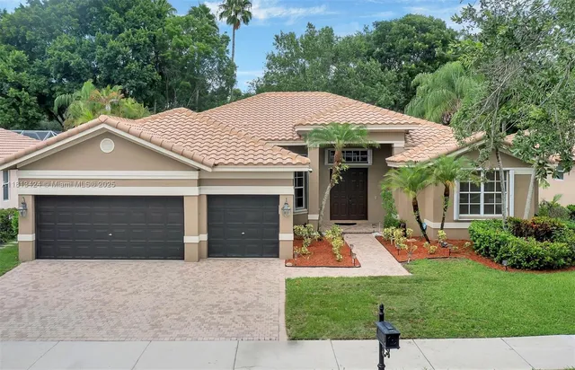 a front view of a house with a yard garage and outdoor seating