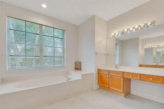a spacious bathroom with a large tub and shower