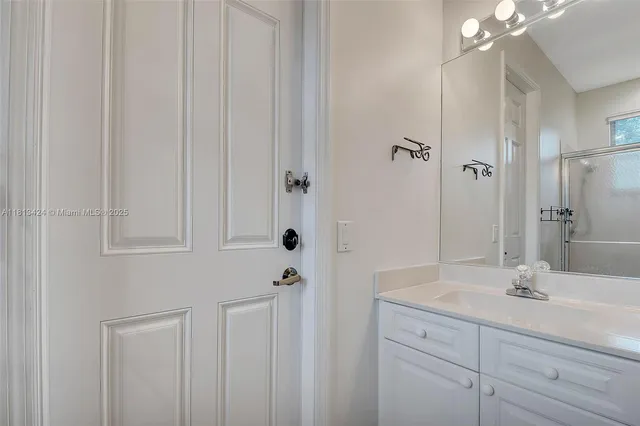 a bathroom with a shower and a sink