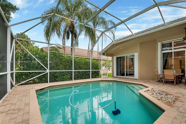 a view of a backyard with a patio and a yard