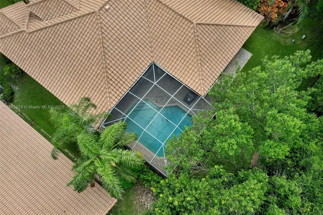 a backyard with potted plants and a wooden bench