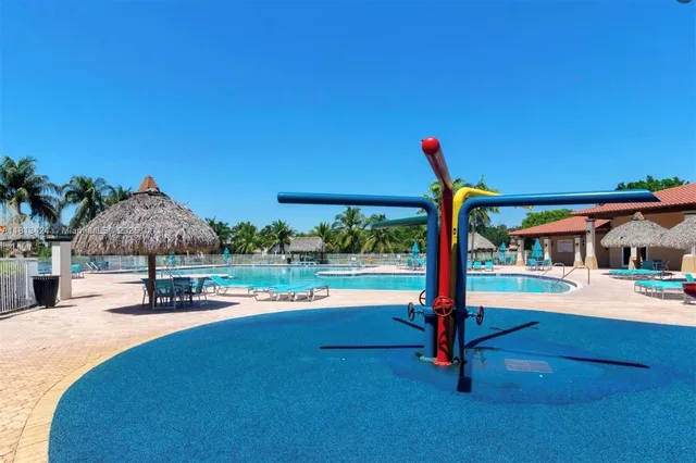 a swimming pool with outdoor seating and yard
