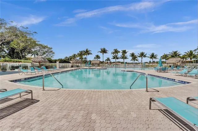 a view of a swimming pool and an outdoor seating