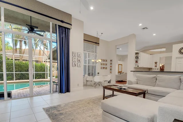 a living room with furniture and a glass door