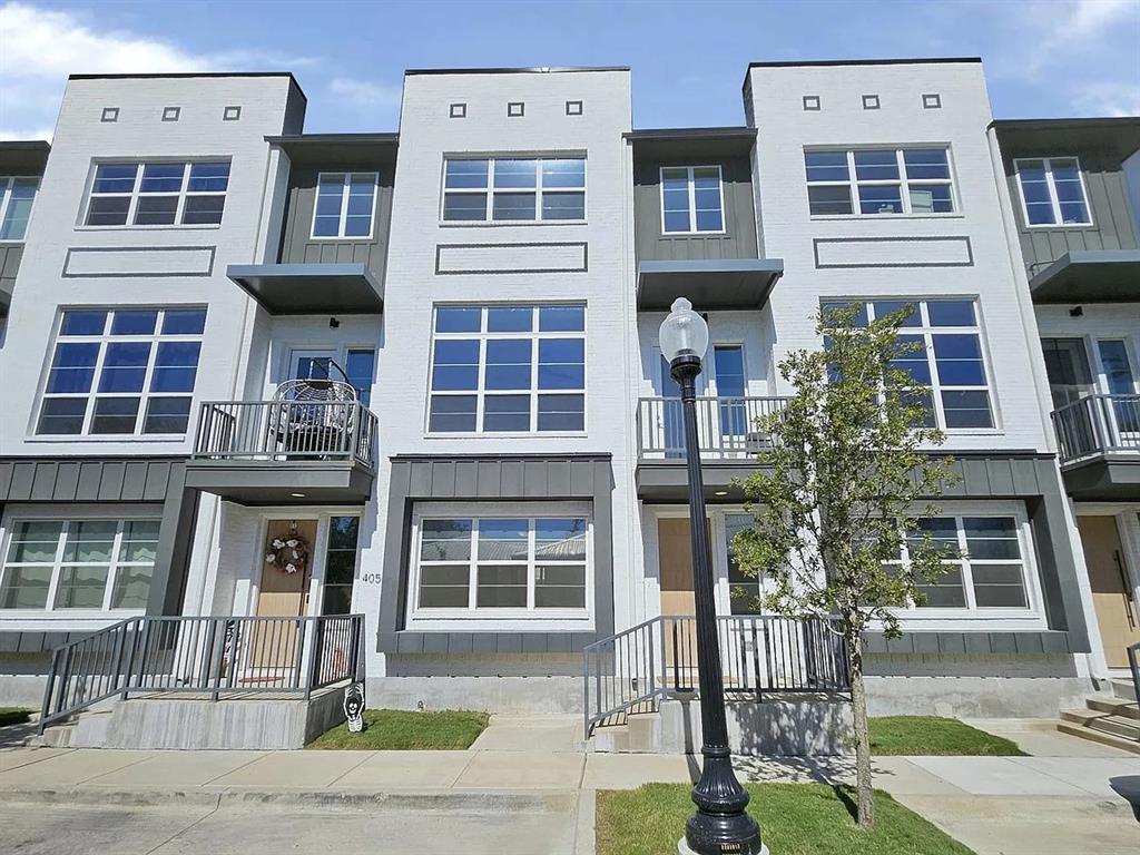 13325 Bee Street, Unit 406 Farmers Branch, TX 75234 - Photo 1 of 30 View of front facade featuring board and batten siding and a balcony
