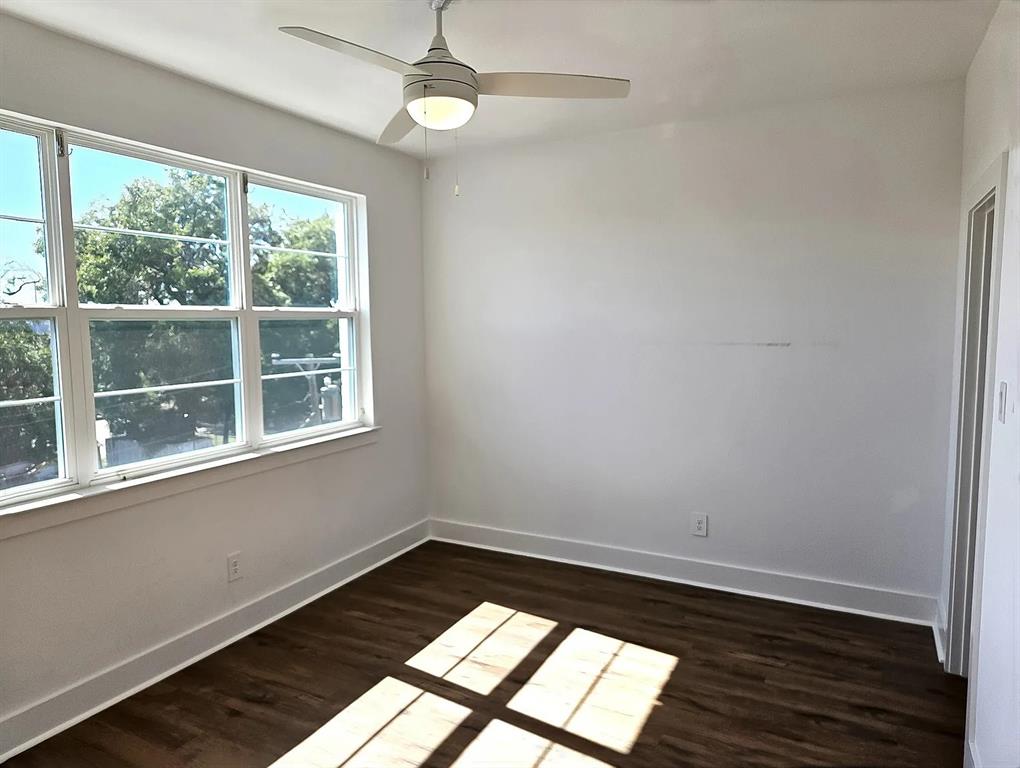 13325 Bee Street, Unit 406 Farmers Branch, TX 75234 - Photo 13 of 30 Spare room with dark wood-style floors and ceiling fan