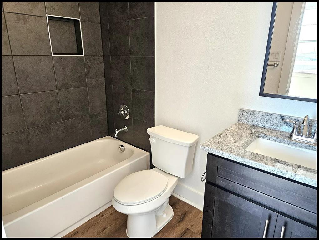 13325 Bee Street, Unit 406 Farmers Branch, TX 75234 - Photo 14 of 30 Full bath with vanity, dark wood-type flooring, and shower / bathtub combination